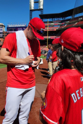 Quinn getting a baseball signed by the Cardinals