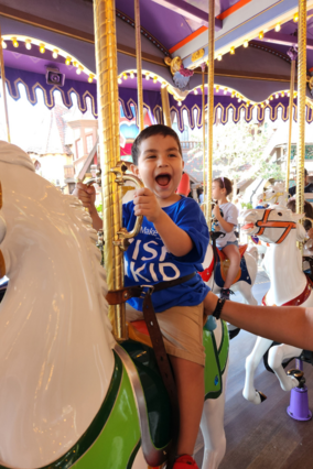 Wish Kid smiling on carousel