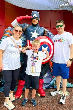 Noah and his family pose with Captain America during his wish trip to Disney World
