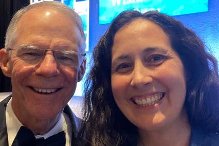 Selfie of Elisa at Wish Ball in front of a sign that reads "Thank you wishmakers"