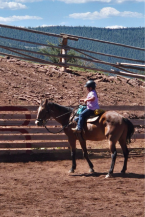 Olivia riding a horse