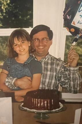 Kristen McElliott poses with her dad as a child.