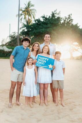 Grace and her family on the beach in Hawaii