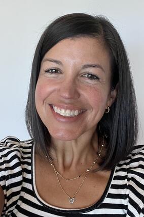 Emily in a black and white striped T-shirt