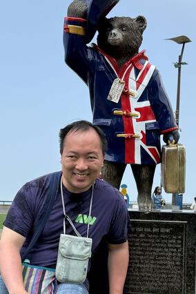 Robert posing in front of a bear statue
