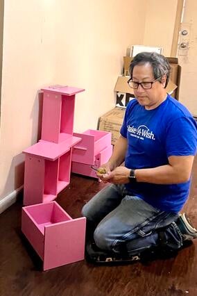 Darin assembles a dresser for a bedroom makeover wish.