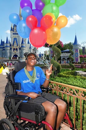 Avant in front of the disney castle with mickey balloons