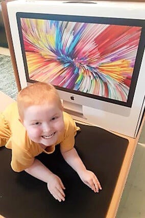 Lana smiles at the rainbow of colors displayed on her new computer.