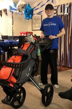 Elijah poses with his gifts from his online shopping spree.