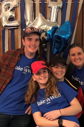 Elijah and his family pose with his gifts from his online shopping spree.