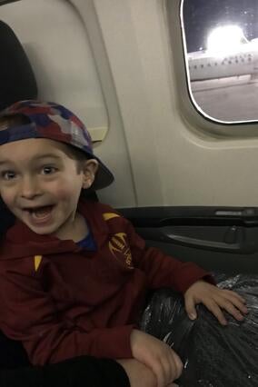 Henry enjoys his ride on a plane.