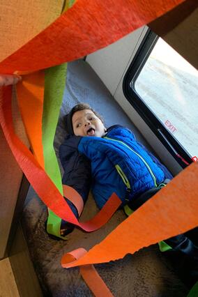 Khami lays down in the bed of his camper for the first time.