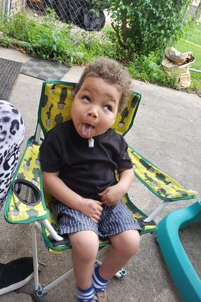 Khami sits outside and enjoys the sunshine.