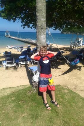 Liam in front of a tree