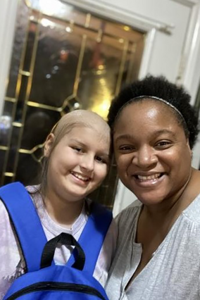 Volunteer Sophia with a wish kid