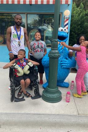 Demetrics and his family meeting Cookie Monster