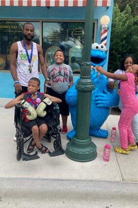 Demetrics and his family meeting Cookie Monster