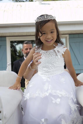 Journi getting into her horse drawn carriage at her princess ball