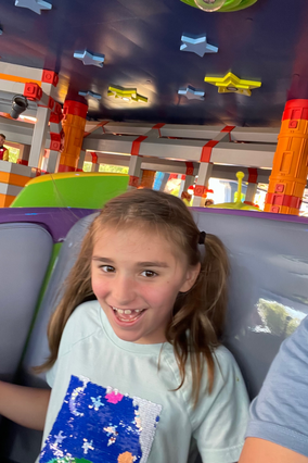 Wish kids Madeline on a ride at Disney World