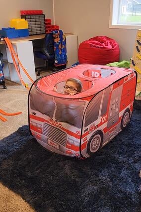 wish kid harrison playing in new play room
