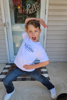 Rowan posing with excitement ready to leave for his wish trip