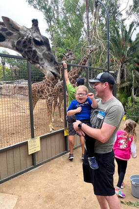 Andrew feeds the giraffes.