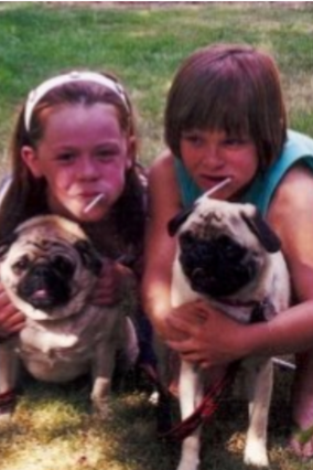 Katie and Jamie pose with puppies