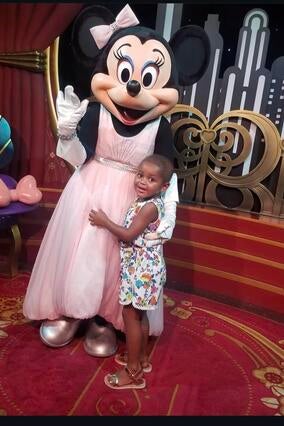 Wish kid Selia at Disney World with Minnie Mouse