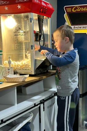 Wish kid Isaac getting popcorn in his new home theater