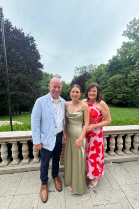 Wish alumni Elizabeth standing with her parents