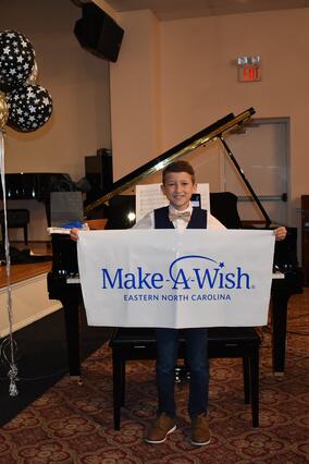 Wish kid Gavin with his piano