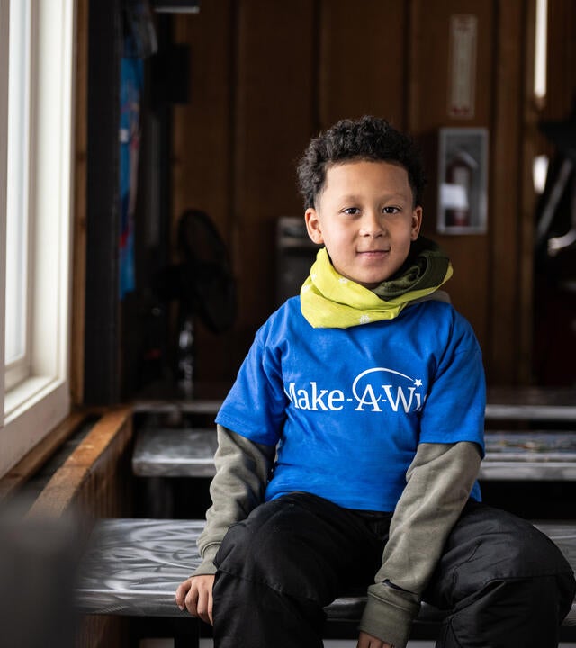 Wish kid Levi putting on ski gear for his wish