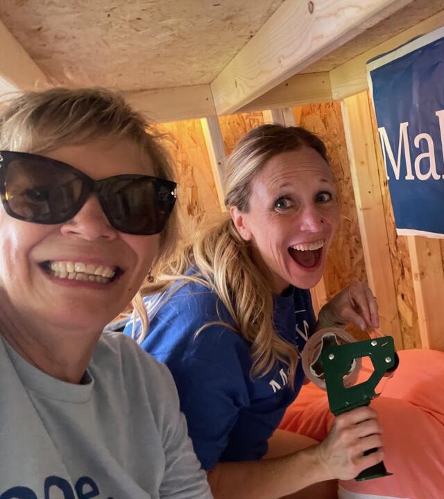 Volunteers putting together a playhouse. 