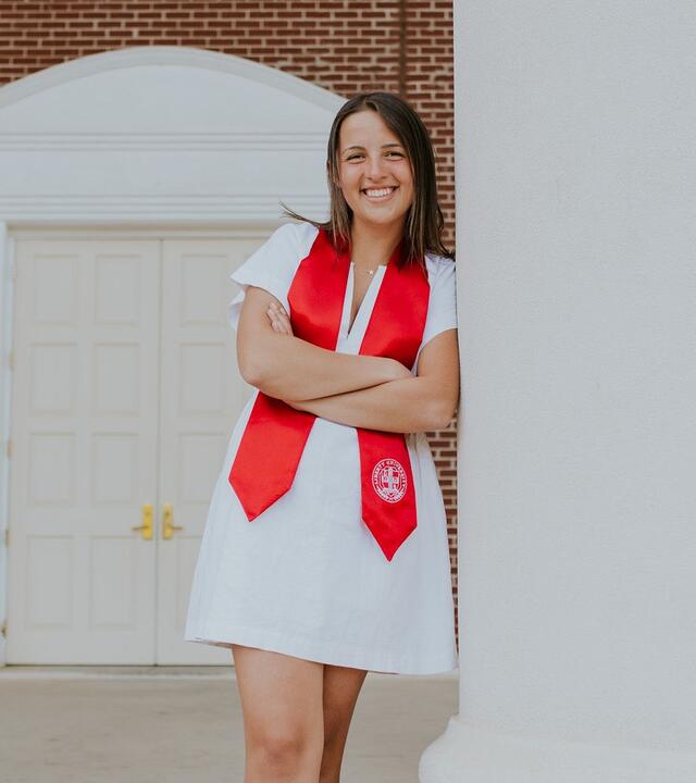 Wish alumni Danielle wearing her college graduation stole