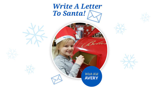 Wish kid Avery puts her letter to Santa in the red Macy's mailbox.