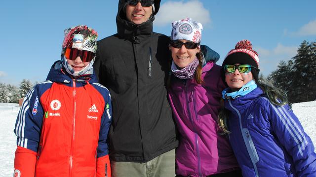 Dr. Carlson with husband and two children in ski gear, in the snow