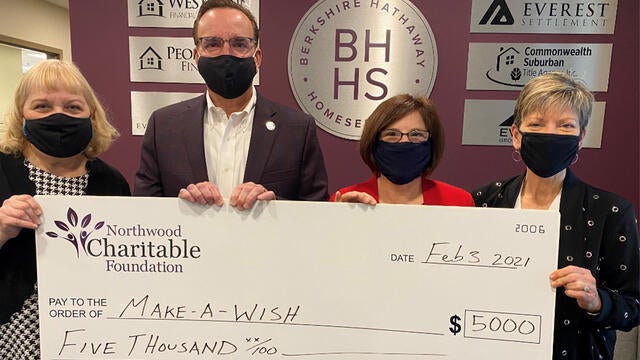 Pictured here are Associates of Berkshire Hathaway HomeServices The Preferred Realty with Make-A-Wish Director of Development, Stephanie Pugliese.