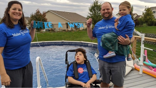 Owen and his family pose in front of his new pool.