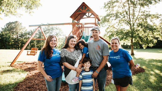 Johanna and her family in front of the playset