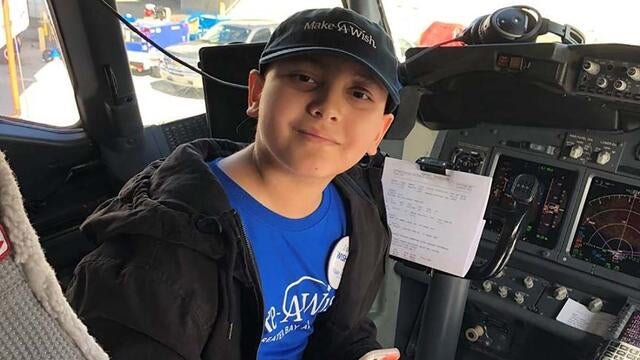 wish kid in pilot seat on a plane