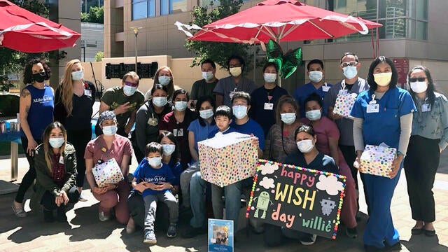 Wish kid Willie with his family, nurses, and Make-A-Wish volunteers and staff on his wish day