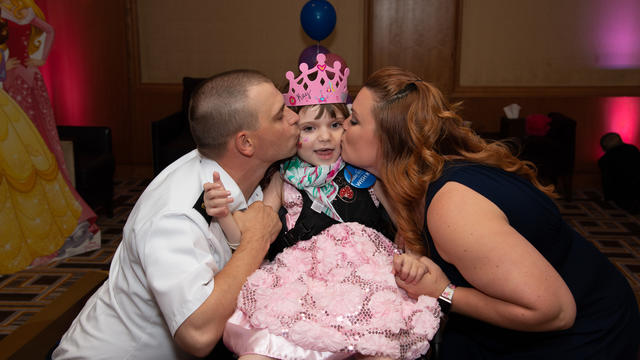 wish kid Kay dressed as princess with her family