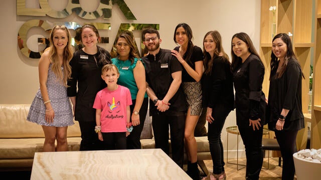 Holly and Kayla pose for a photo with the spa team.