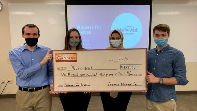 Students of Gannon University presenting their donation to wishes.