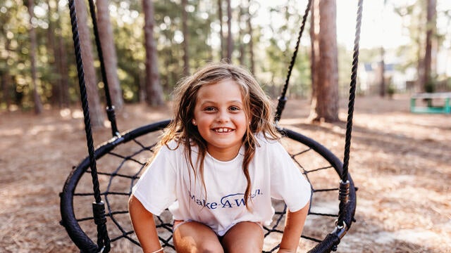 Caroline smiles on her new swing