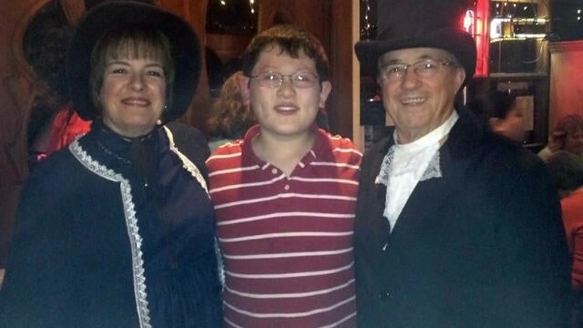 Volunteer wish granters Brenda and Joe with wish kid Alex