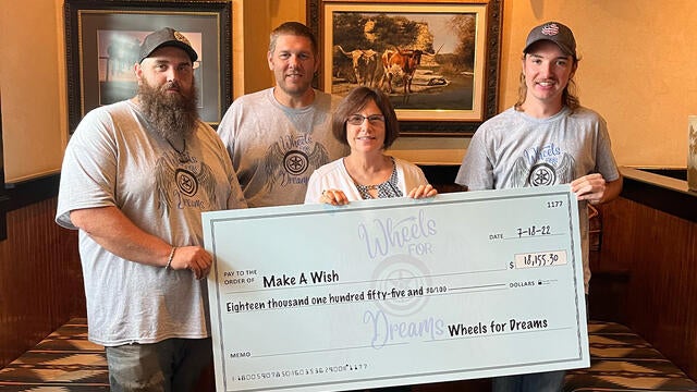 Wheels for Dreams check presentation for wishes in 2022 with Director of Development Stephanie Pugliese.