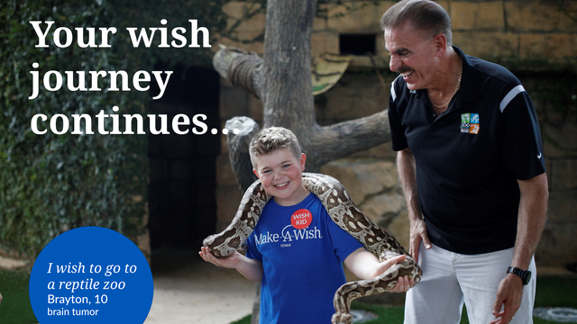 Wish child Brayton holds a snake next to a zookeeper at the Miami Zoo.