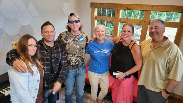 Billy, family, and volunteers inside his music shed