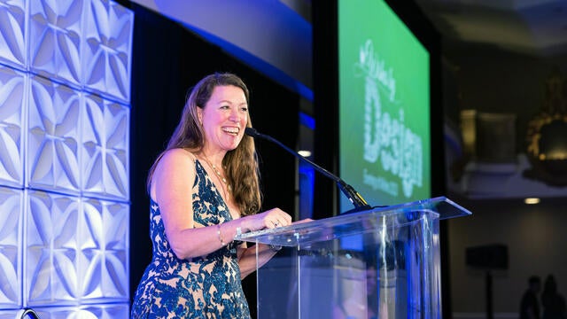 Betsy Biern gives an address on stage